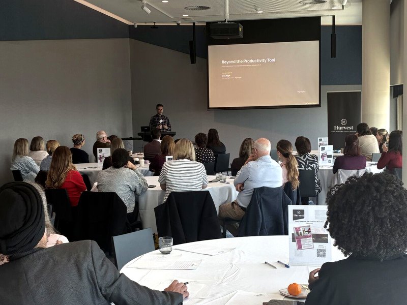 Hypergen Managing Director Alex Papli presenting to a full room of business leaders at tables with printed materials