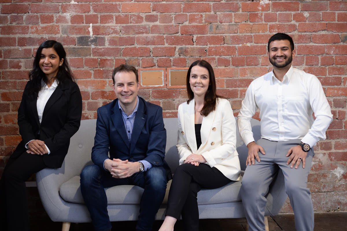 The Hypergen team sitting together on a couch, smiling
